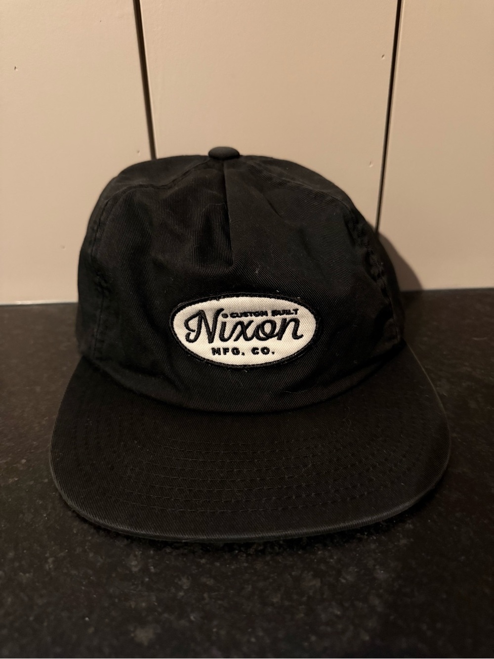 Nixon Black Cap with White Oval Logo Patch SnapBack Adjustable Hat